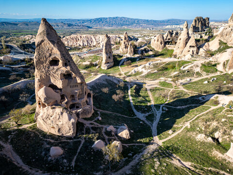 Aerial view of Uchisar Castle, a prominent rock-cut fortress, surrounded by unique fairy chimneys and volcanic landscape in Cappadocia, Uchisar, Nevsehir, Turkiye.