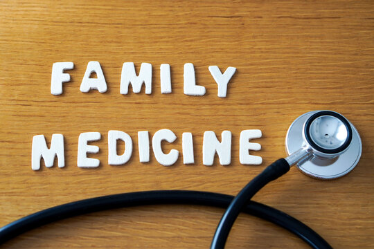 The words "family medicine" formed with wooden letters, accompanied by a black medical stethoscope.