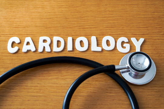 The word cardiology formed with wooden letters, accompanied by a black medical stethoscope.
