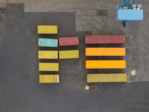 Aerial view of colorful shipping containers at the Haven Genk cargo terminal, showcasing industrial logistics and intermodal freight transport infrastructure in Genk, Vlaanderen, Belgium.