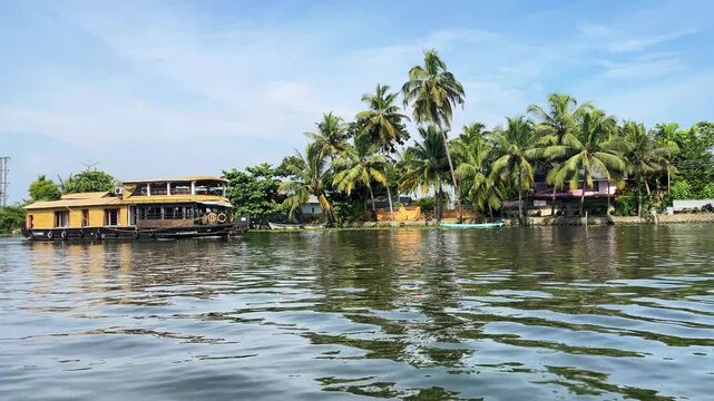 Traditional Kerala Houseboat Cruising in Backwaters Surrounded by Coconut Palms. 