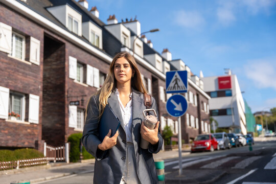 Professional woman walking urban street commuting to work