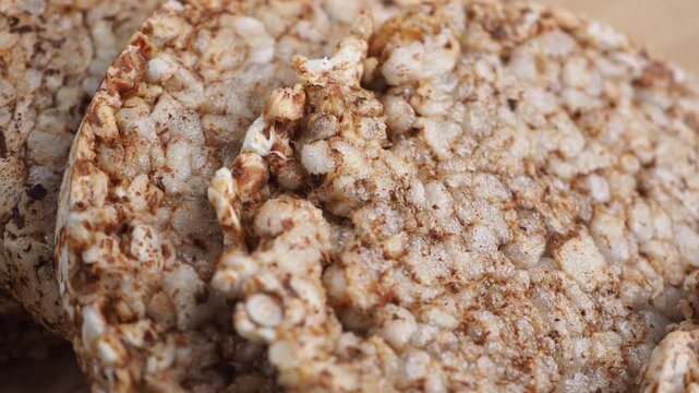 Close up motion of crispy puffed multigrain rice cakes snack with textured surface macro shot