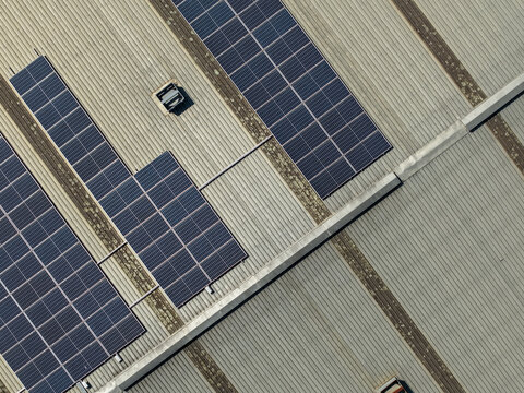 Aerial view of solar panels installed on a corrugated metal roof of a factory building in Kilsyth, Victoria, Australia.