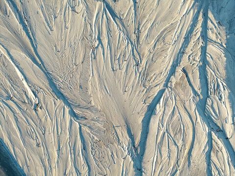Aerial view of abstract sand textures and river water patterns forming intricate natural shapes in Poland.