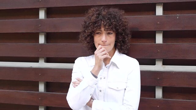 A Portrait of a Thoughtful and Reflective Young Woman with Beautiful Curly Hair and Poise