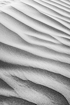 Monochrome black white sand dune ripple wave pattern natural texture minimal abstract desert flowing detail. Elegant nature closeup design scene. Neutral contemporary surface fine art wall decor