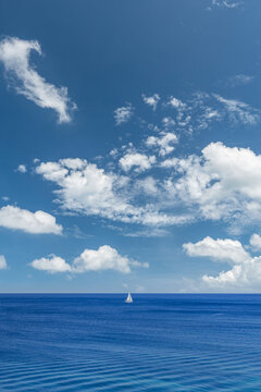 Amazing nature seascape minimal ocean view tiny white sailboat deep blue sea calm horizon artistic. Zen meditation relax wellbeing scene. Peaceful tranquil coastal solitude summer travel earth