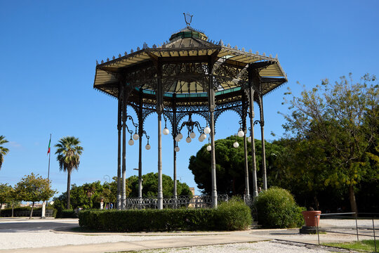 Catania, Italy; 1st September 2026: Scenic view of Parco Maestranze in Catania with lush Mediterranean trees and historic architecture