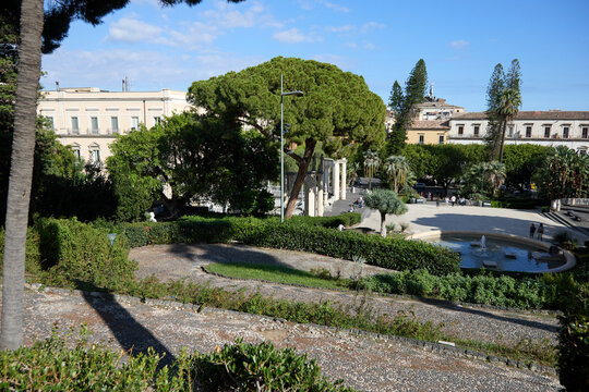 Catania, Italy; 1st September 2026: Scenic view of Parco Maestranze in Catania with lush Mediterranean trees and historic architecture