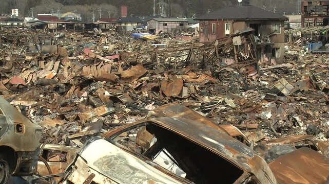 Burnt Out Vehicles And Debris In Aftermath Of Tsunami In Japan