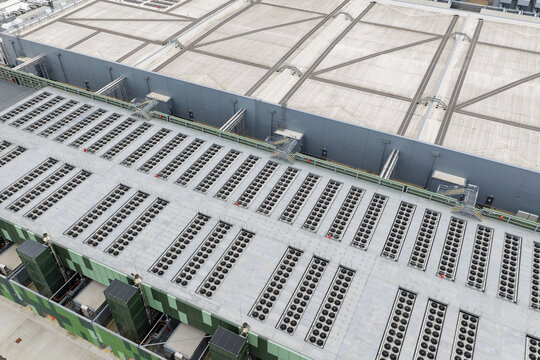 Aerial view of a large data center roof featuring rows of industrial cooling fans and HVAC units in the United Kingdom.