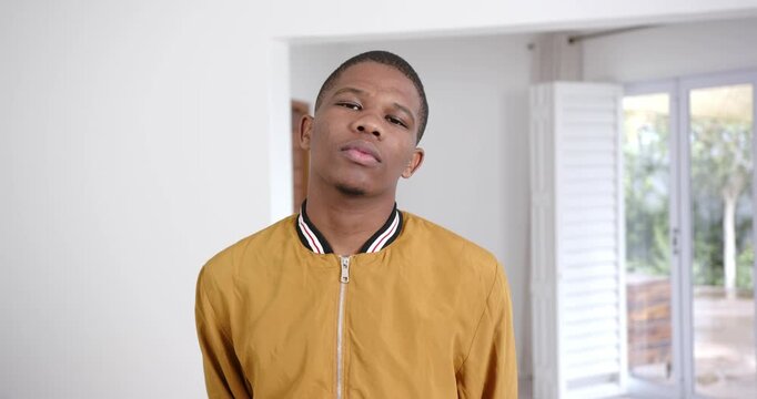 High speed photography for dynamic scenes, Young man in yellow jacket standing indoors, looking at c