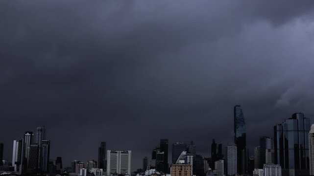 Time-Lapse of Dark storm clouds gathering over the Bangkok skyline before heavy rainfall.