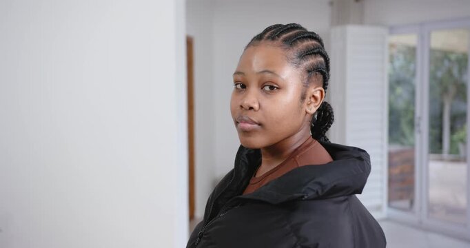High speed photography for dynamic scenes, woman with braided hair wearing black jacket, looking con