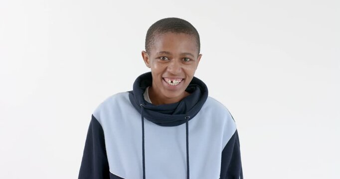 High speed photography for dynamic scenes, Smiling person in hoodie looking down, feeling happy and