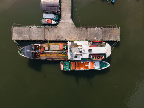 Aerial view of Sleko Port with ships docked at the concrete pier in Cilacap, Central Java, Indonesia.