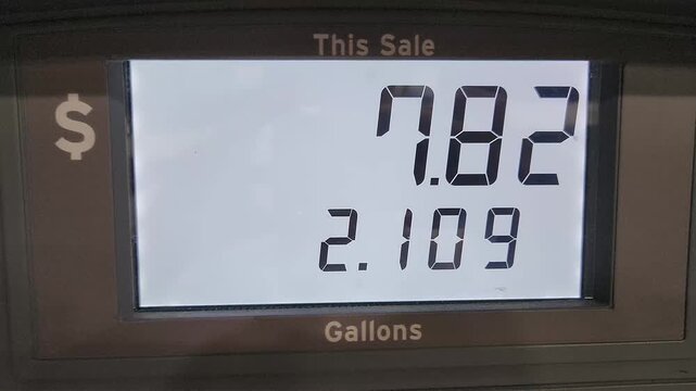 Digital sale and gallon counters on a gasoline pump during refueling