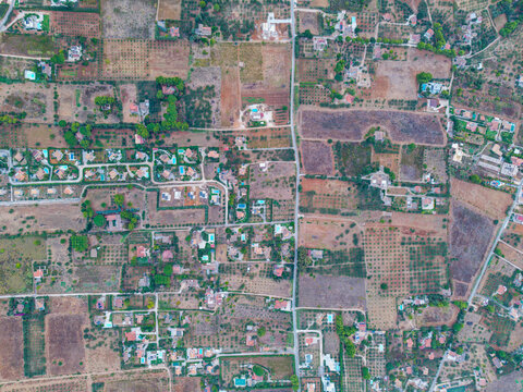 Aerial view of the rural landscape near Palermo, featuring scattered houses, agricultural plots, olive groves, and a network of narrow roads in Palermo, Sicily, Italy.