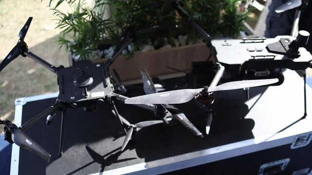 Military multirotor drones displayed with carbon fiber frames powerful propellers and landing gear showing modern UAV engineering for tactical reconnaissance missions