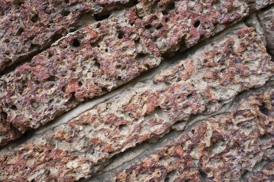 Textured surface of an ancient laterite stone brick wall background