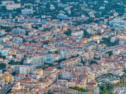 Aerial view of the coastal city of Cannes featuring dense urban architecture, historic buildings, terracotta rooftops, and winding streets in Cannes, Provence-Alpes-Cote d'Azur, France.