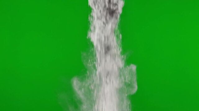 Gray ash particles falling in a slow vertical descent isolated on a green screen background