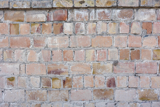 Professional brickwork masonry surface representing a solid foundation and building construction.  Urban grunge background with old textured red brick wall.