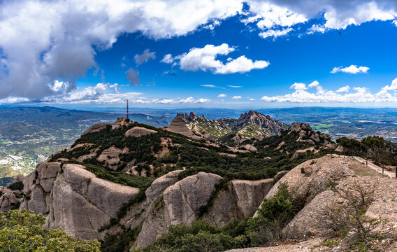 Panorama view of round rocky mountains with the peak of Sant Jeroni and Catalan Central Depression in Montserrat near Barcelona on a sunny spring day, Catalonia, Spain