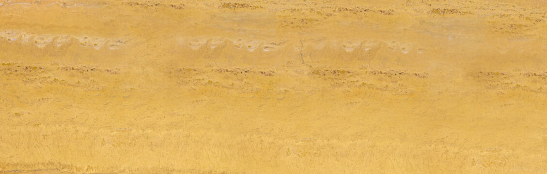 Bright warm yellow marble slab texture background with horizontal natural grain