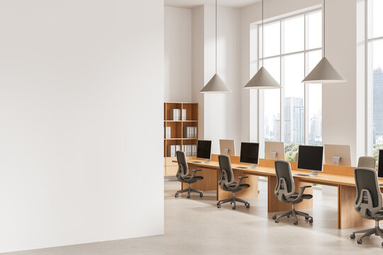 Modern Office Interior with Empty Wall Mockup, Desks, Chairs, Pendant Lights, City Windows, and Spacious Workplace Design Template. 3D Rendering