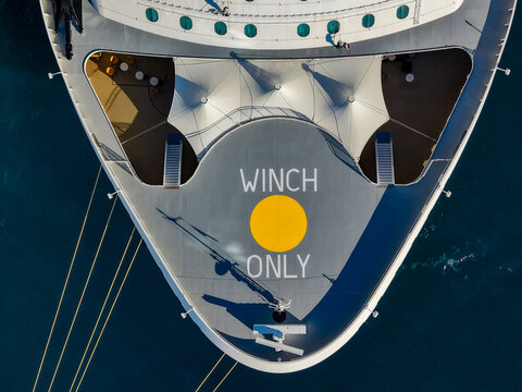 Aerial view of the bow of a cruise ship at Nassau Cruise Port with a winch only marking and yellow circle on the deck in Nassau, The Bahamas.