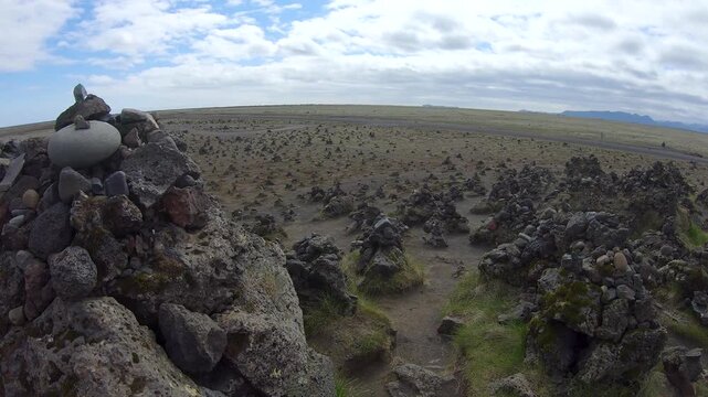 Laufskalavarda lava field, Iceland, covered with hundreds of small stone cairns piled by travelers, a local custom said to bring good luck on the journey.