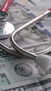 Stethoscope and money arrangement showing health care or medical costs