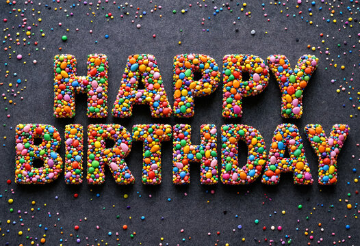 Colorful candy letters spelling happy birthday celebration message design