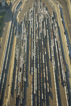 Aerial view of a large rail yard with numerous freight train cars parked on parallel tracks in Kansas City, Missouri, United States.