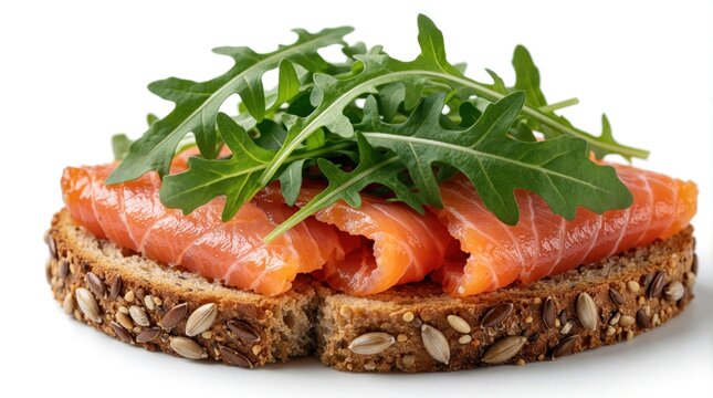 Delicious smoked salmon, fresh arugula on whole grain rye bread. Healthy salmon sandwich with green rocket leaves on toasted multigrain bread. Tasty seafood snack light breakfast meal served on