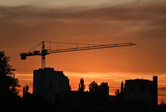 Construction site against bright sunset