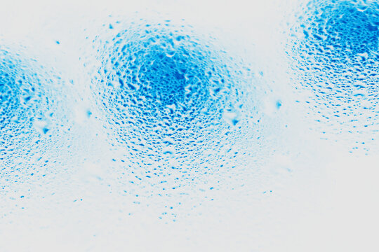 Abstract close-up of light blue dots forming organic, cellular patterns on a white background. Minimalist texture, perfect as a background for graphic design, packaging, and visual concepts.