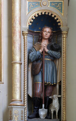 Saint Isidore, statue on the altar of Saint Anthony of Padua in the parish church of the Sacred Heart of Jesus in Velika Pisanica, Croatia © zatletic