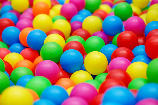 Colorful plastic balls filling ball pit background
