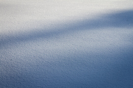 Natural winter backdrop featuring white snow texture. Winter white snow surface as background.