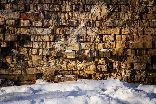 Old abandoned brick wall in winter. Architectural detail.