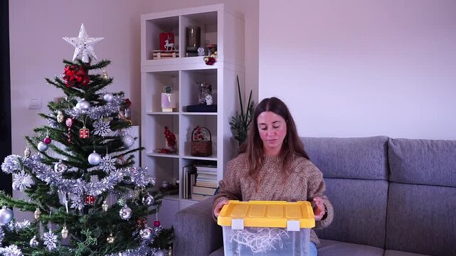 Frustrated woman untangling christmas tree lights