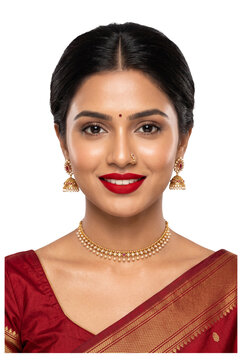 Beautiful South Indian woman in traditional maroon saree and gold jewelry isolated on transparent. Elegant ethnic portrait with pearl necklace and Jhumka for bridal or festive celebration.