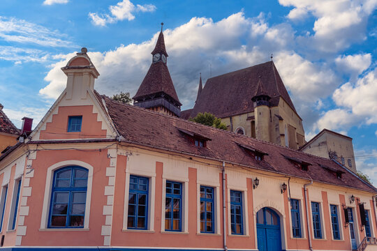 Biertan fortified church rising above historic village buildings in Transylvania Romania