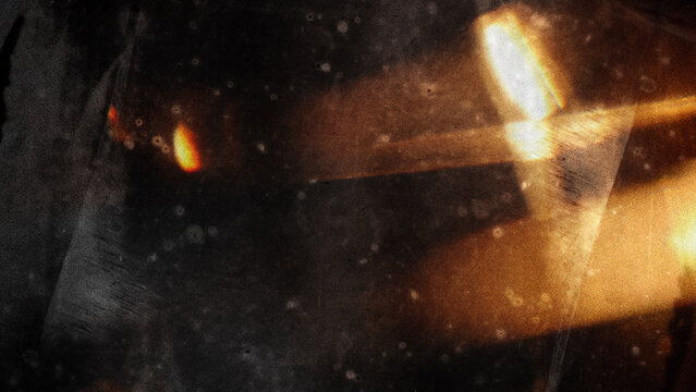 Warm amber light leak overlay texture with film grain, scratches, and soft glow on dark background