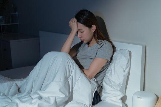 Anxiety disorder on insomnia woman concept, sleepless Woman open eye awakening on the bed at night time can't sleep from symptom of depression diseased.