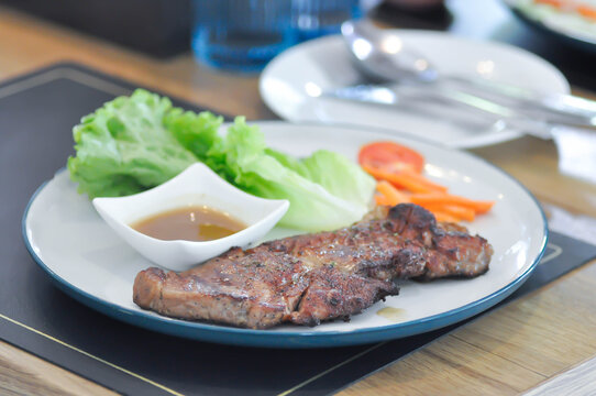 pork steak or grilled pork and salad or pork chop and vegetable