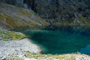 The green waters of a mountain pond. Czarny Staw pod Rysami, Tatra Mountains. © Tomasz